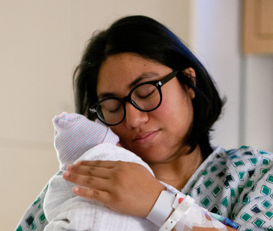 Mum holding her baby in a hospital