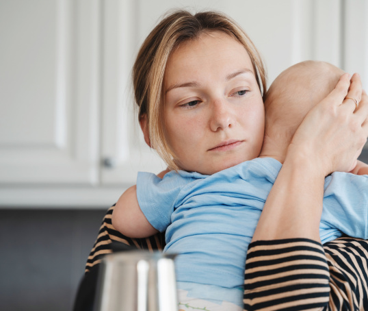 Mother holding sick baby