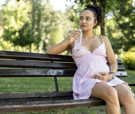 Pregnant woman or birthing person in park