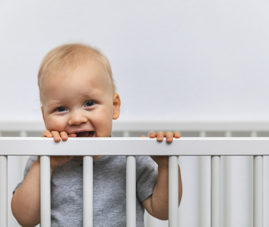 Toddler in cot