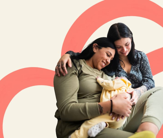 Two mums holding newborn