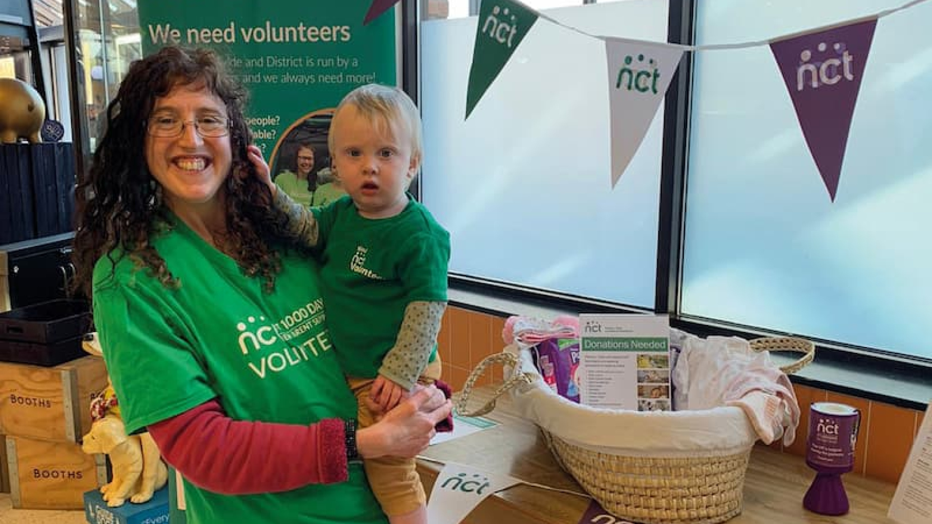 Volunteer with their child at a NCT event