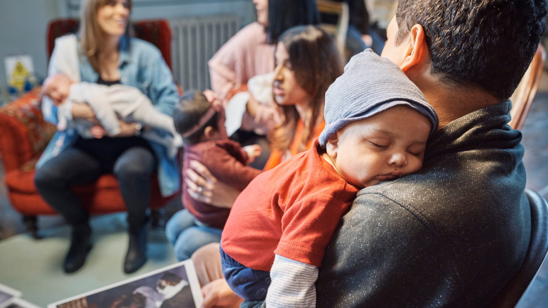 Baby asleep on dad's shoulder