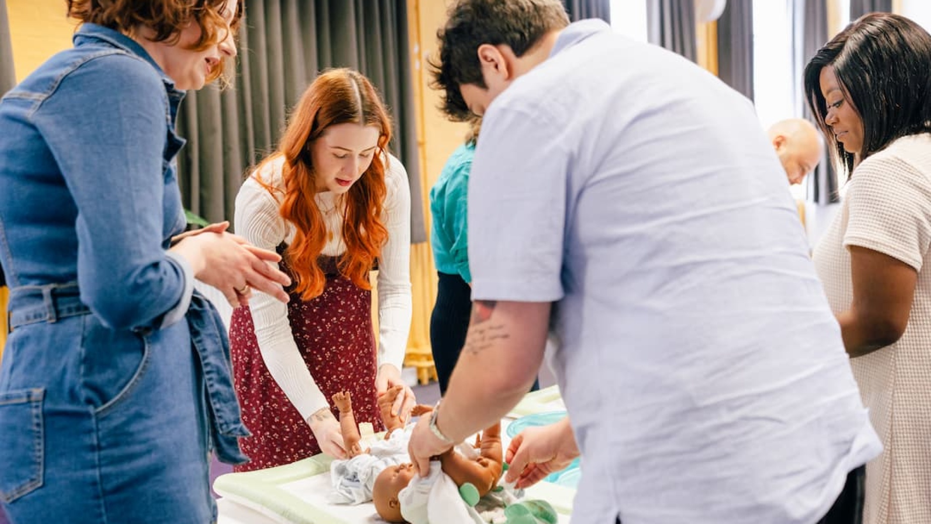 Antenatal class learning to change a nappy