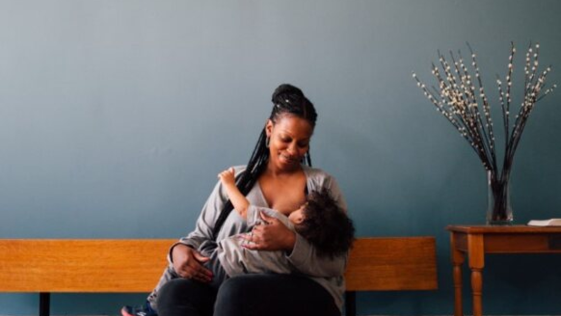 Newham mother breastfeeding baby on a bench