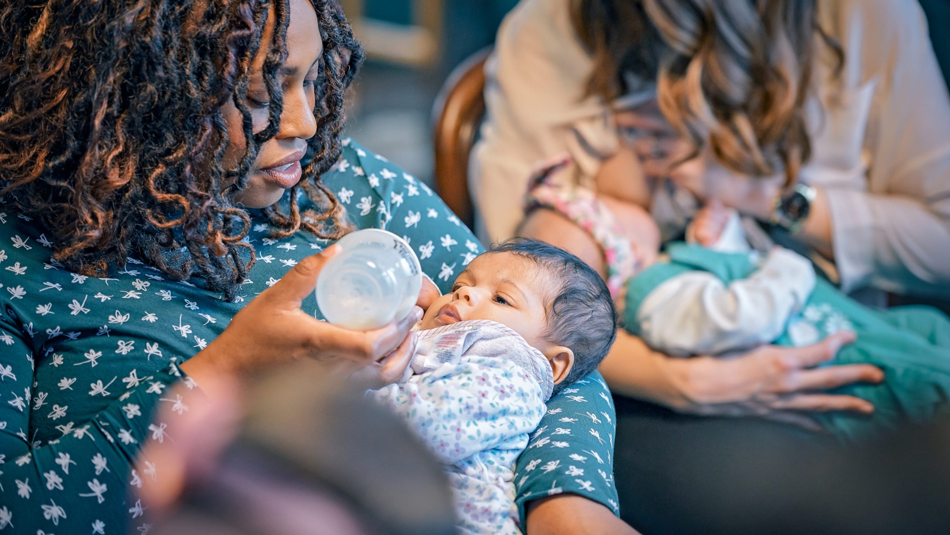 Mum bottle feeding baby