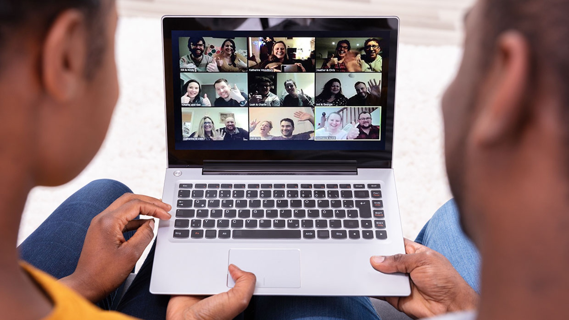 Two parents on a video call at a laptop