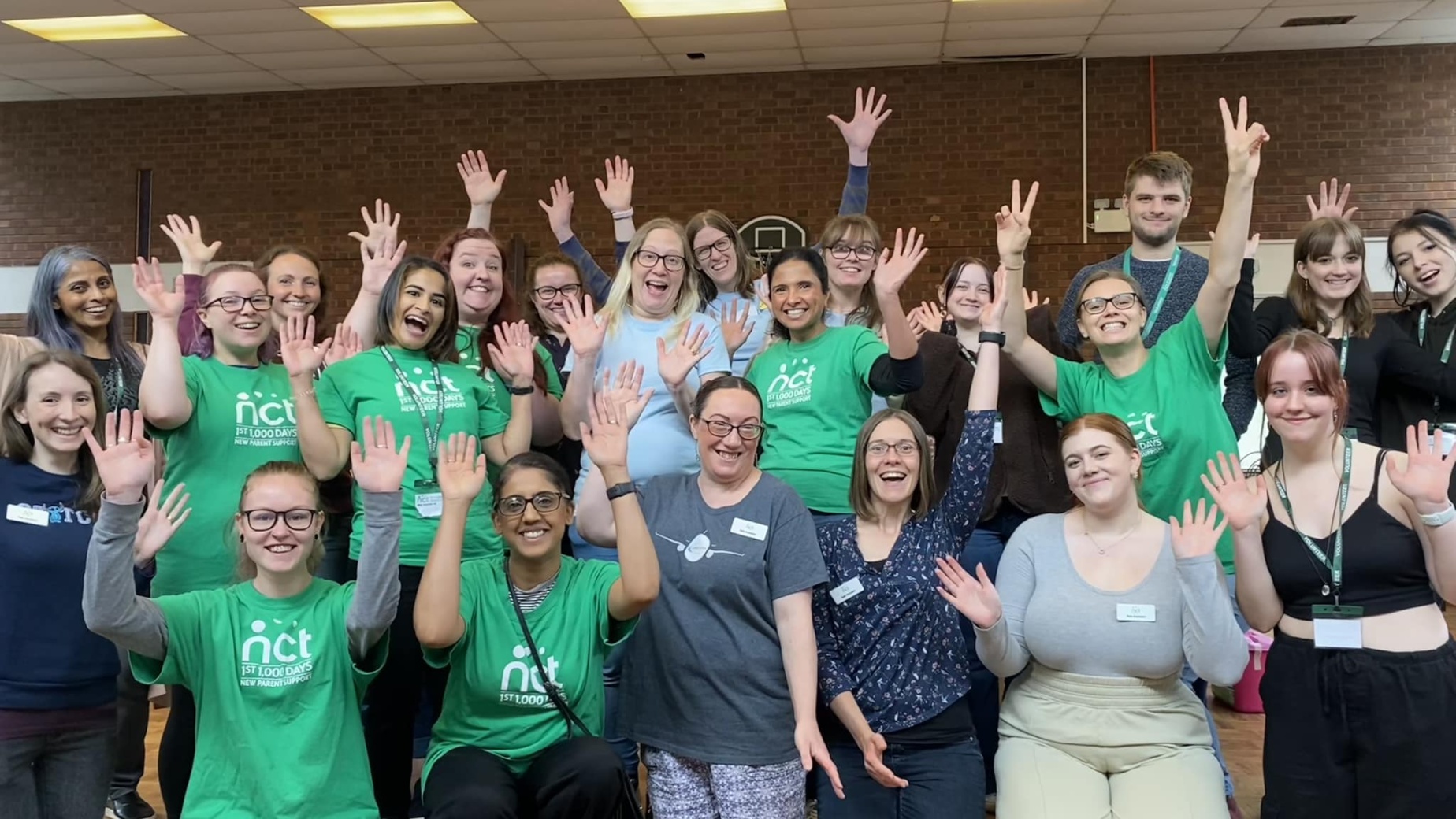 Nearly New Sales volunteer group smiling and waving