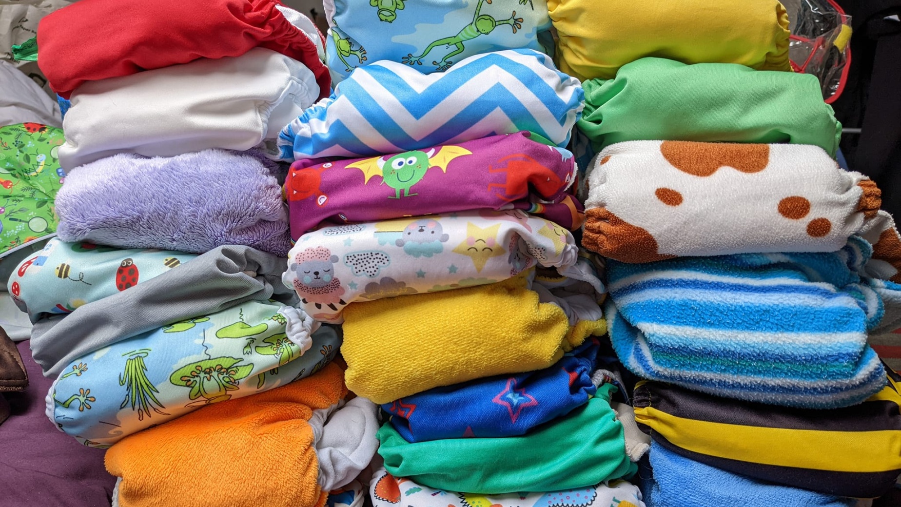 Pile of folded colourful cloth nappies