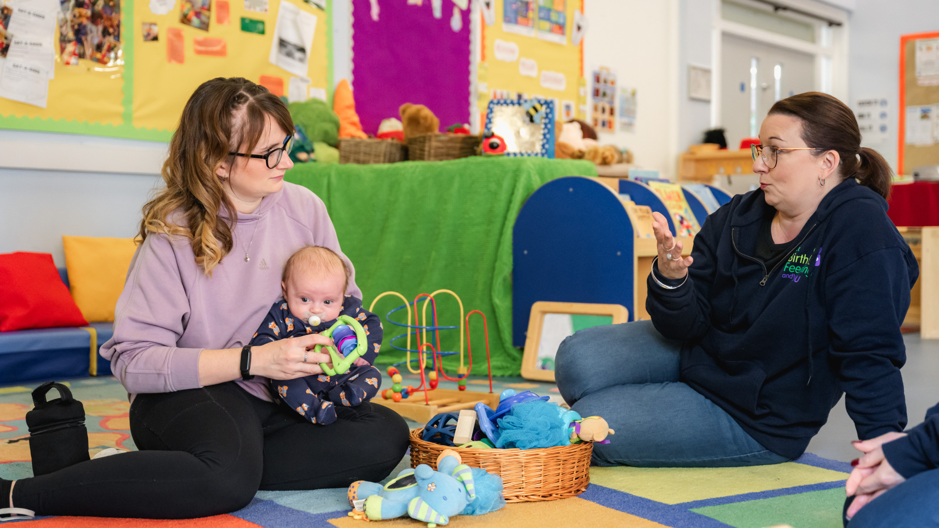 Peer supporter talking to mum and baby