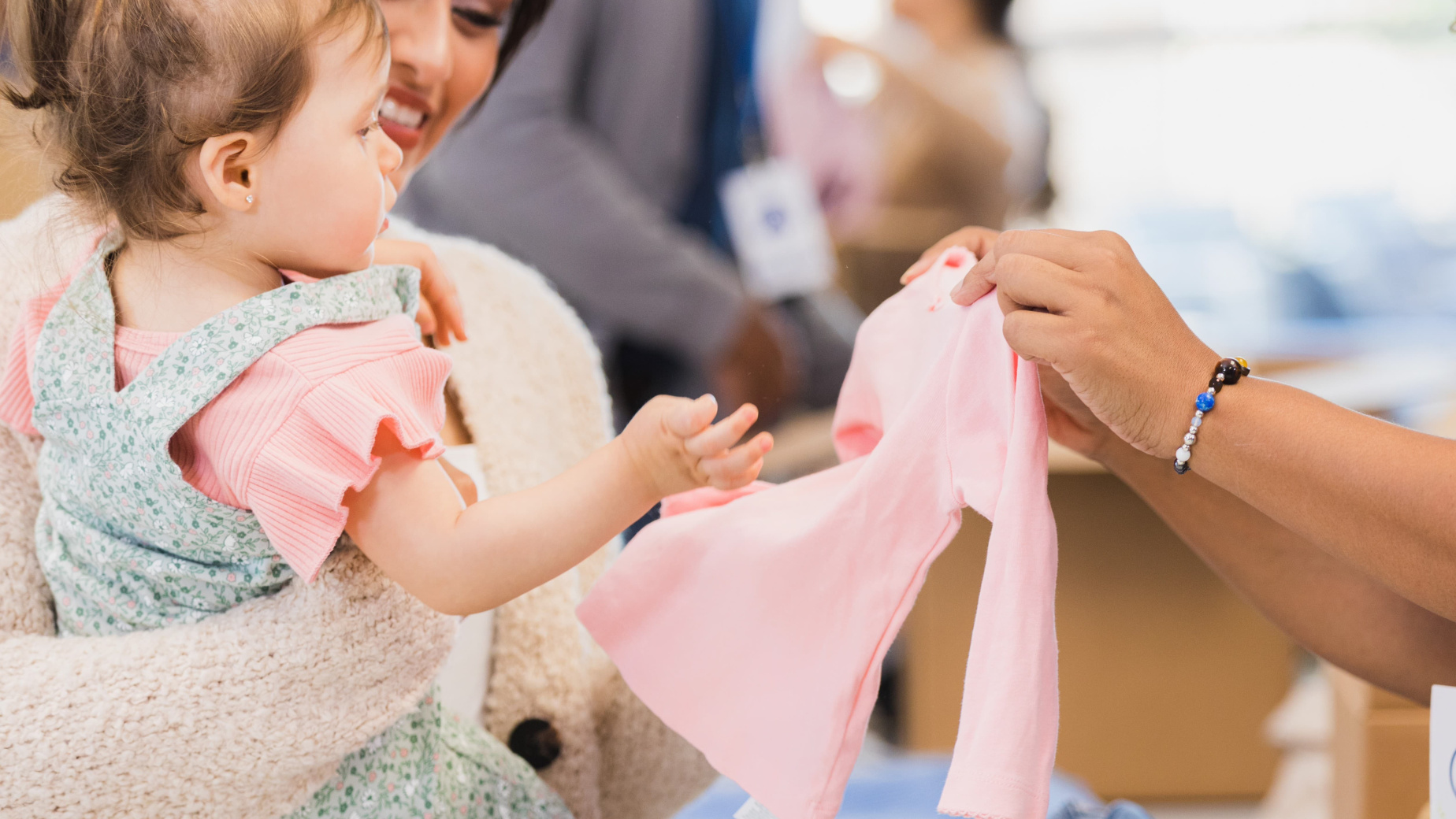Mum and toddler at a clothes sale