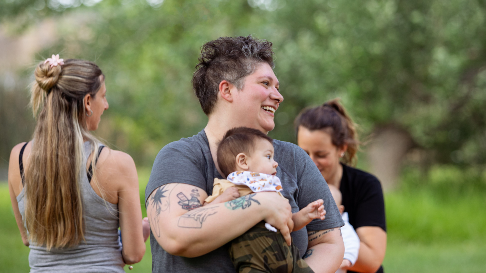 Three mums in a park with their babies