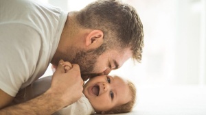 dad kissing baby
