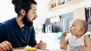 dad and baby talking and eating
