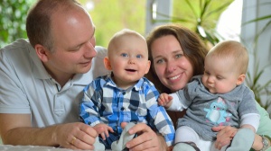 A family looking happy with twin babies
