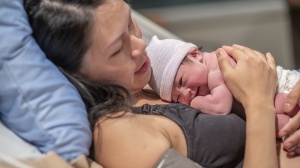 Woman having just given birth to her baby