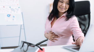 Pregnant woman working at her desk
