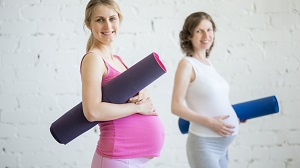 Pregnant women with yoga mats