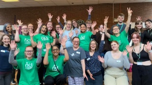 Nearly New Sales volunteer group smiling and waving