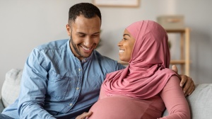 Couple with hands on baby