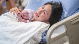 Woman or birthing parent with baby