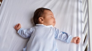 Baby asleep in a cot