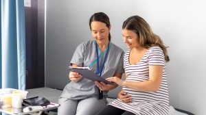 Pregnant parent looking at notes