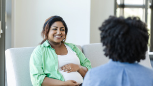Mother or birthing person talking to midwife