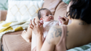Parent looking at baby on a sofa