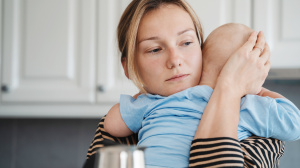 Mother holding sick baby