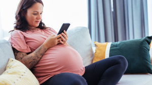 Pregnant woman looking at phone