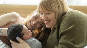 Parents with baby on bed