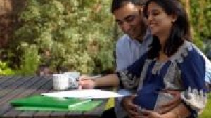 Couple hugging discussing birth plan