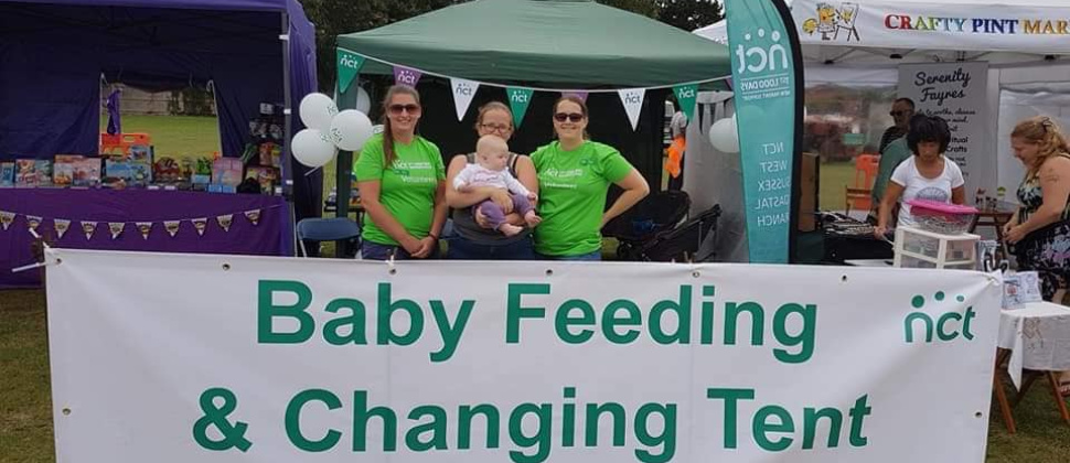 Image of volunteers with baby feeding and changing tent