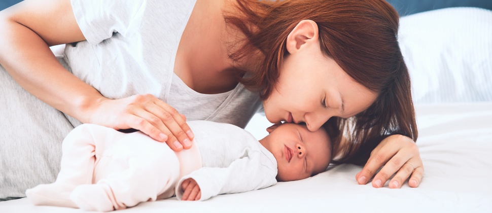 Mum kissing baby