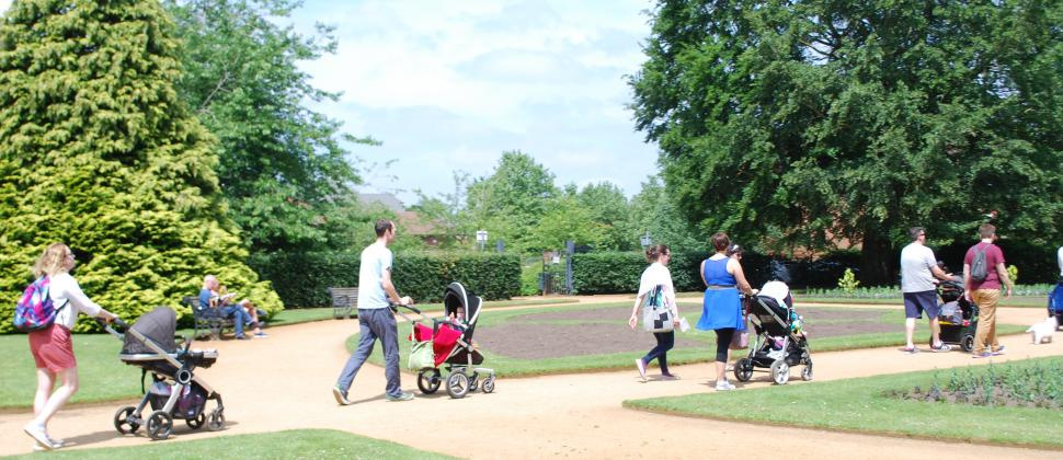 Parents walking with pushchairs