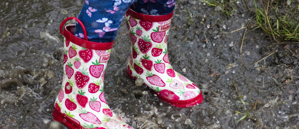 pink wellies jumping in a puddle