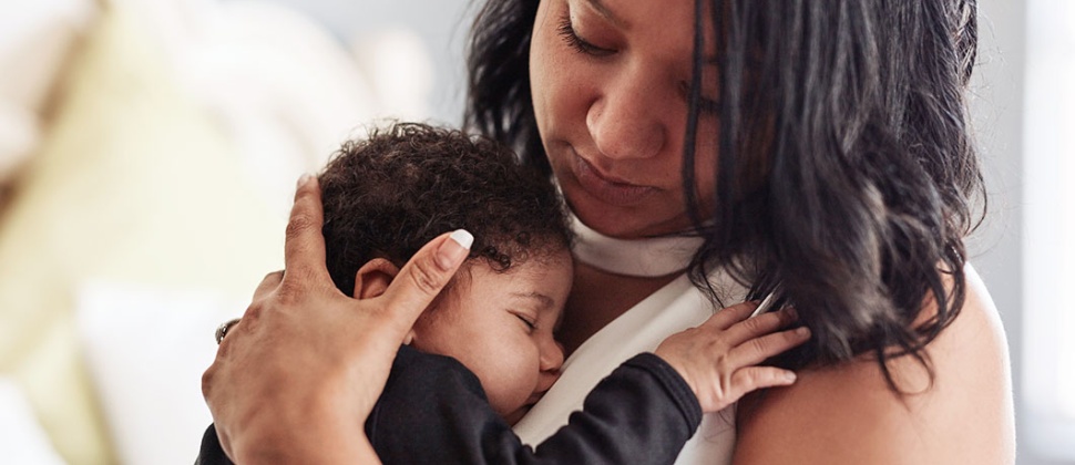 Woman holding sleeping baby 