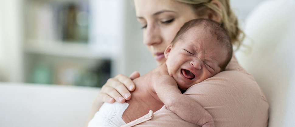 Mother holding crying baby