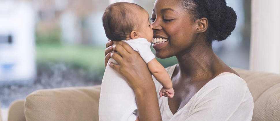 Mother holding baby to face
