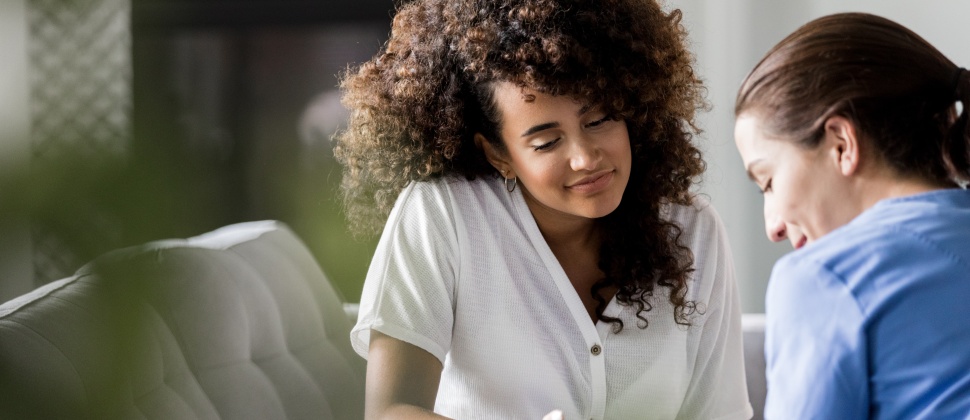 Pregnant mum talking to friend