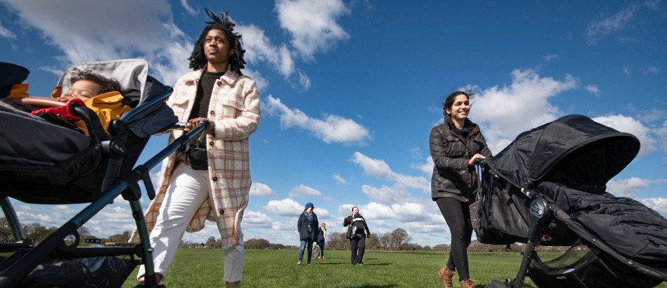 Parent's pushing prams outdoors