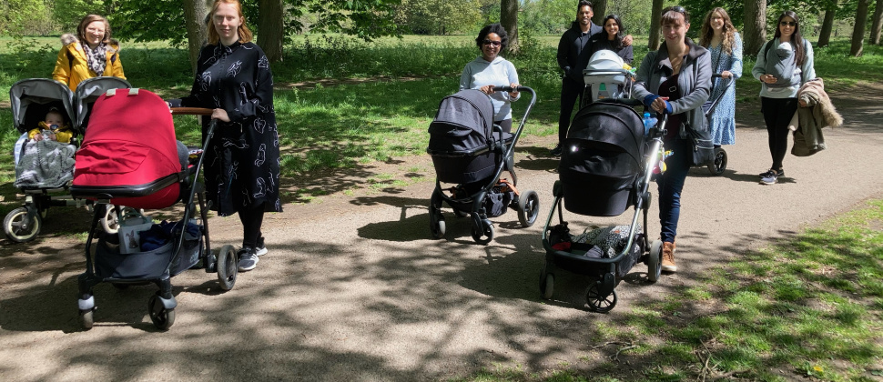 parents walking in a park with buggies