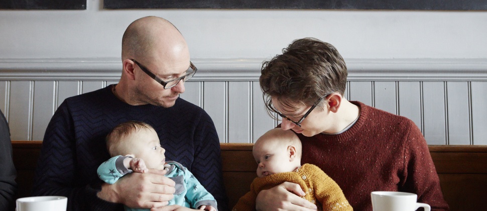 Dads holds baby drinking tea