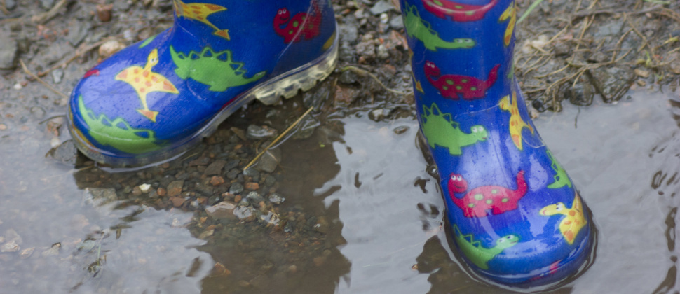 child's wellies in a puddle